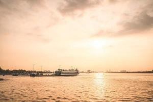 Ho Chi Minh, VIETNAM - FEB 19 2022 Transportation for export, import at Cat Lai port on Sai Gon river, crane load container to boat, this harbor is big industry service for trade photo