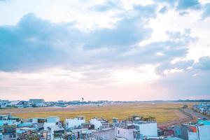 Ho Chi Minh city, Vietnam - FEB 12 2022 Airplane fly over urban areas preparing landing into Tan Son Nhat International Airport and takes off in TSN airport photo