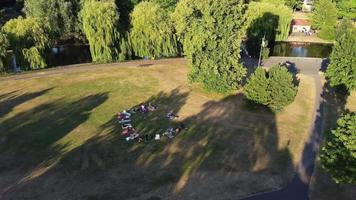 Group of Women Exercising Yoga Together in the Public Park at Sunset of Hot Summer, Aerial High Angle View of Free Access Wardown Public Park Luton England UK