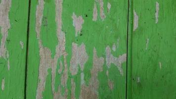 Old wooden wall surface with peeling paint background photo