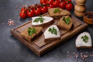 Appetizer, baguette with liver paste and herbs, closeup. Homemade breakfast photo