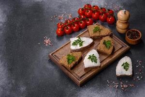 Appetizer, baguette with liver paste and herbs, closeup. Homemade breakfast photo
