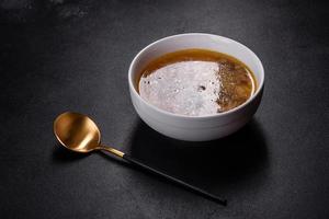 Mushroom soup plate with porcini mushrooms, fresh parsley and pepper photo