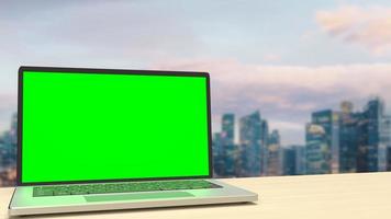 The notebook display green screen on rooftop building  for present concept 3d rendering photo