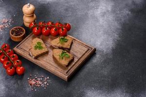 Appetizer, baguette with liver paste and herbs, closeup. Homemade breakfast photo