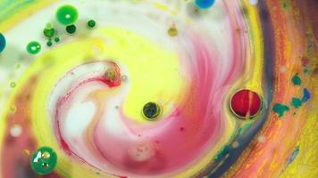 Colorful abstract bubbles and drops on the yellow pink and white water surface video