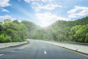 Beautiful highway road of Thailand with green mountain and blue sky background photo