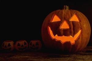 Halloween pumpkin head jack lantern on wooden background photo