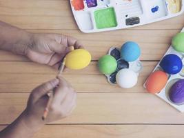 People painting colorful Easter eggs - Easter holiday celebration concept photo