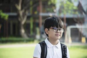 Young Asian Thailand boy happy going to school - children back to school concept. photo