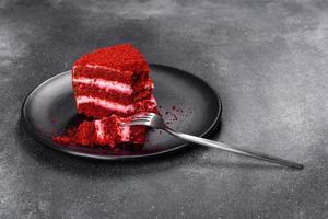 Red velvet cake, classic three layered cake from red butter sponge cakes with cream photo