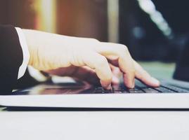 Business man is using laptop computer in his office photo