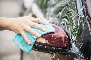 Man wash car using shampoo - every day life car care concept photo