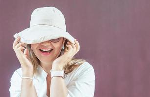 Women with white hat and white dress with sunglasses photo