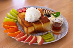 Honey toast with ice cream and mixed fruit photo