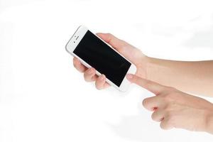 Hand holding mobile smart phone with blank screen on white background photo