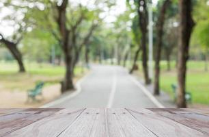 Empty perspective white wood over blurred trees with bokeh background, for product display photo