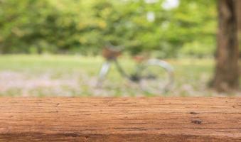 Wood table top on blur green abstract background for display your products photo