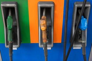 Gas pump nozzles in a service station photo