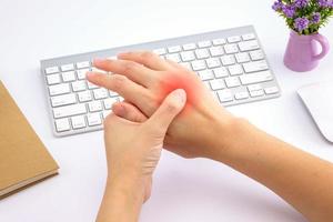 Young woman hand pain with red alert accent photo