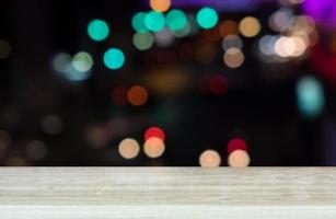 Empty top wooden table and blur with Lights of Traffic jam in city. For product display photo