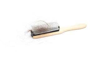 Comb with hair loss problem on white background photo