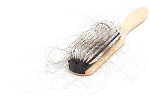 Comb with hair loss problem on white background photo