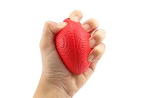 Woman hand squeezing a stress ball  on white background photo