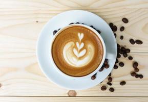 Coffee cup with on wooden table. View from the top photo