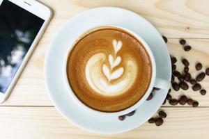 Coffee cup with on wooden table. View from the top photo