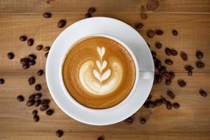 Coffee cup with on wooden table. View from the top photo