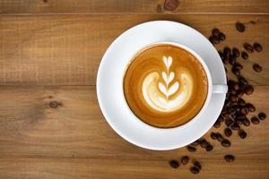 Coffee cup with on wooden table. View from the top photo