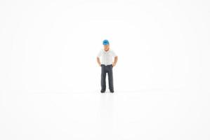 Miniature people engineer worker construction concept isolated on white background on white background photo