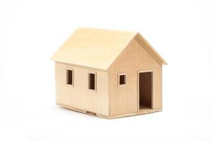 Toy wooden house model on white photo