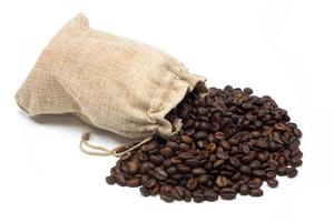 Coffee beans with burlap bag on white background photo