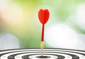 Target dart and arrow with abstract nature bokeh blur background. photo