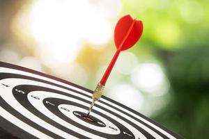 Target dart and arrow with abstract nature bokeh blur background. photo