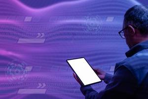 Man standing holding blank white screen tablet. The concept for communicating with mobile devices, internet connection financial transactions, banking, hacking. Closeup copy space, Effect background photo