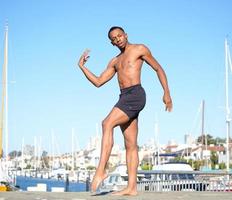 Ready to move to a new role dancer against the backdrop of a blue sky and sailboats photo