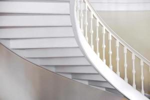 Curved view of under the white vintage stairs. photo