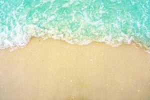 The light wave and beautiful green sea with space for texts on the beach background.. photo