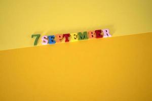 Calendar date of September 7 on a yellow background. photo