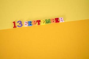 September 13 on a yellow background with room for text. photo