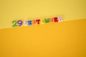 Calendar date of September 29 on yellow, paper background. photo