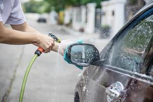 Man wash car using shampoo - every day life car care concept photo