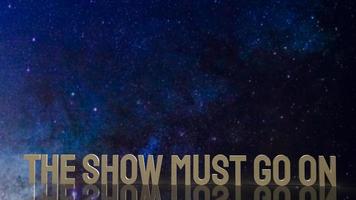 gold text the show must go on for present background photo