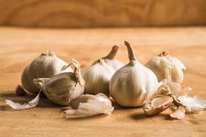 Fresh garlic on wooden table background. photo