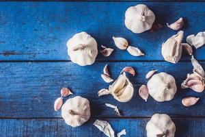 Top view of  Garlic on blue wooden table background.
