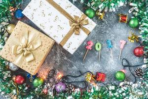 Top view of Gift boxes with Christmas decoration on gray grunge background. photo