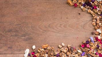 Top view workspace with dried flowers on wooden table background .Free space for your text. photo